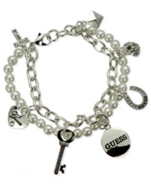 GUESS doubles the style factor with this two-row charm bracelet. Crafted from silver-tone mixed metal, the bracelet pops with glass pearls and crystal accents. Item comes packaged in a signature GUESS Gift Box. Approximate length: 7-1/2 inches long. Approximate diameter: 1-1/2 inches. Approximate drop: 1/2 inch. GUESS doubles the style factor with this two-row charm bracelet. Crafted from silver-tone mixed metal, the bracelet pops with glass pearls and crystal accents. Item comes packaged in a signature GUESS Gift Box. Approximate length: 7-1/2 inches long. Approximate diameter: 1-1/2 inches. Approximate drop: 1/2 inch.