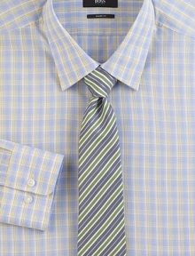 A smart plaid in softened shades on pure cotton.Modified point collarButton frontBarrel cuffsCottonDry cleanImported