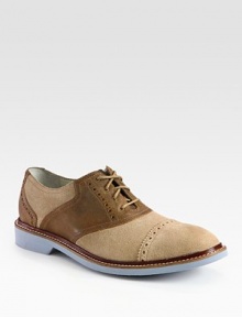 Signature saddle shoe design in leather and suede with a refined, perforated detail.Suede/leather upperLeather liningPadded insoleFoam soleImported