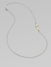 A simple, sleek cross of 14k gold sits sideways within a delicate sterling silver chain in this eloquent design.14k yellow gold and sterling silverLength, about 18Spring ring claspMade in USA A simple, sleek cross of 14k gold sits sideways within a delicate sterling silver chain in this eloquent design.14k yellow gold and sterling silverLength, about 18Spring ring claspMade in USA