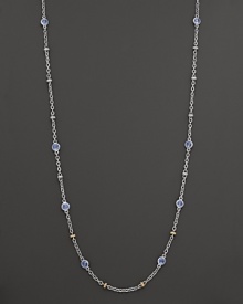 Stations of blue topaz shine on this elegant sterling silver necklace with 18K yellow gold accents. By Judith Ripka.