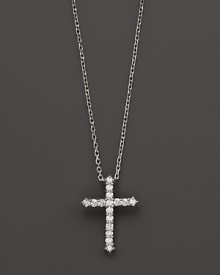 Diamonds, set in 14K white gold, form a chic cross.