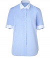 Simple, blue cotton button-down- Short sleeves and button placket- Straight, loose cut with rounded hem- White cuffs and collar add interest to the classic style - Great when paired with skinny jeans or nude shorts and flat sandals