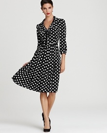 Playful polka dots lend a cheerful look to a timeless Anne Klein swing dress, exuding a faint retro feel. Playful polka dots lend a cheerful look to a timeless Anne Klein swing dress, exuding a faint retro feel.