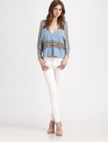 Airy cotton jersey and chambray in a draped dolman pullover accented with woven tribal-print trim.V necklineDropped shouldersDolman sleevesAbout 23 from shoulder to hemCottonDry cleanImportedModel shown is 5'10 (177cm) wearing US size Small.