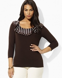 A sleek jersey top is given a feminine feel with charmeuse ruffles at the scoop neckline. A sleek jersey top is given a feminine feel with charmeuse ruffles at the scoop neckline.