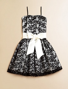 She'll be simply stunning in this lace frock with a princess-like full skirt and fancy ribbon tie.Straight necklineSpaghetti strapsBack zipperWaistband with ribbon tieFull skirtPolyesterDry cleanImported of domestic fabric She'll be simply stunning in this lace frock with a princess-like full skirt and fancy ribbon tie.Straight necklineSpaghetti strapsBack zipperWaistband with ribbon tieFull skirtPolyesterDry cleanImported of domestic fabric
