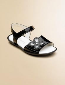 Polished patent leather in a graceful design with a glittery flower on the front strap for added sparkle and shine.Double grip-tape ankle strapLeather upperLeather liningRubber solePadded insoleImported Polished patent leather in a graceful design with a glittery flower on the front strap for added sparkle and shine.Double grip-tape ankle strapLeather upperLeather liningRubber solePadded insoleImported