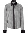 Ultra-luxe black and white houndstooth print silk top - This classic top will add a sophisticated touch to any basic - Perfect for the office, this silk blouse looks great with a pencil skirt and pumps - Pair with a structured blazer and a mini skirt for an updated suit