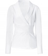 Luxe top in fine, white cotton and nylon stretch blend - Elegant, deep v wrap style fuses the look of a blazer with that of a blouse - Small collar, wide lapels and long sleeves - Wide sash belt ties at back, cinching the waist - A chic, eye-catching alternative to the classic button down - Pair with pencil skirts, suit trousers or cigarette pants