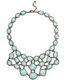 Spruce up your summer look in Monet's statement-making necklace. A rich bronze tone mixed metal setting provides the perfect backdrop for bold reconstituted turquoise stones. Approximate length: 17 inches + 2-inch extender. Approximate drop: 2-3/4 inches.