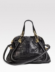 Exotic python crafted into a gracefully tapered shape. Double top handles, 5 drop Detachable tube shoulder strap, 16 drop Top zip closure Polished brass hardware and chain link detail One inside zip pocket Cotton lining About 15½W X 10H X 7D Made in Italy