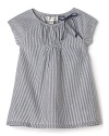 Parisian-inspired stripes and a delicate neckline bow detail add a stylish accent to a short sleeve dress from Pearls & Popcorn.