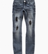 Grunge meets glam in these distressed Guess jeans styled with tears, sequins and attitude.