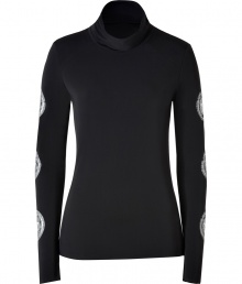 Hit the slopes in ultra chic style in Jet Sets soft black stretch ski top - Softly draped turtleneck, long sleeves with silver star circle print, raw finished seams - Form fitting - Team with bright white ski pants, aviators, and a finish of fur trimmed accessories