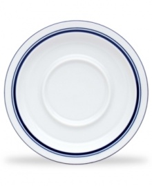 Named for a trendy Copenhagen neighborhood but designed with timeless style, the Christianshavn Blue tea saucer features a double band of navy in pristine white porcelain. From Dansk.