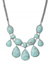 Decorate your neckline with a summery statement maker. Fossil's head-turning design features tiers of oval and teardrop-shaped reconstituted turquoise in vintage-themed bezel settings. Crafted in silver tone mixed metal. Approximate length: 16-1/2 inches + 2-inch extender. Approximate drop: 1-1/2 inches.