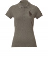 The classic polo gets a high style kick with this figure-flattering and crystal embellished version from Polo Ralph Lauren - Spread collar, short sleeves, front button half placket, large logo at chest, asymmetric hem, side vents - Style with cropped trousers, skinny jeans, or a pencil skirt