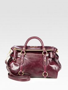 Leather carryall featuring sweet bow accents.Double top handles, 4 dropDetachable shoulder strap, 21½ dropTop zip closureProtective metal feetOne inside zip pocketThree inside open pocketsSatin lining13W X 9H X 6DMade in Italy Leather carryall featuring sweet bow accents.Double top handles, 4 dropDetachable shoulder strap, 21½ dropTop zip closureProtective metal feetOne inside zip pocketThree inside open pocketsSatin lining13W X 9H X 6DMade in Italy