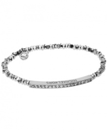 Stackable styles a must! Michael Kors' chic stretch bracelet pairs perfectly with bangles or bracelets. Beads and bar accent are crafted in silver tone mixed metal and accented by pave-set glass accents. Approximate diameter: 2-1/4 inches. Approximate width: 1/8 inch.