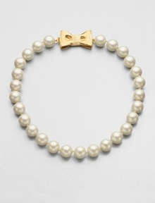 A classic styled piece in pearl-like beads with a sweet goldtone bow closure. Plastic beadsGoldtoneLength, about 18Tongue and box closureImported 