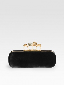 Plush and rich velvet with a skull accented knuckle duster closure.Knuckle duster top clasp closureLeather lining8¾W X 3H X 1½DMade in Italy Plush and rich velvet with a skull accented knuckle duster closure.Knuckle duster top clasp closureLeather lining8¾W X 3H X 1½DMade in Italy