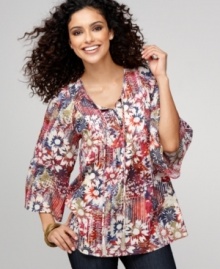 Style&co.'s printed peasant top features a vibrant floral pattern and embroidered front placket, complete with a tasseled drawstring! Perfect for pairing with dark denim.