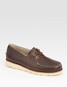 Crafted with boat-shoe inspired styling, this casual comfort essential is highlighted by contrast rubber sole and stitching.Leather upperLeather liningPadded insoleRubber soleImported