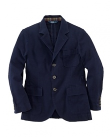 The three-button Langley sport coat is rendered in season-spanning cotton chino and finished with madras plaid lining the collar for a pop of preppy color. The three-button Langley sport coat is rendered in season-spanning cotton chino and finished with madras plaid lining the collar for a pop of preppy color.