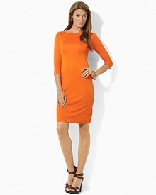 A mod jersey shift dress is crafted with a boat neckline and three quarter sleeves for a sleek look.