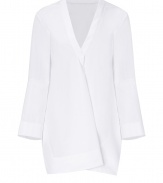 With modern-minimalist detailing and a contemporary cut, Jil Sanders pristine white cotton tunic is an effortless chic choice - V-neckline with folded front detail, long sleeves, cut-out slit sides, longer back - Loose fit - Wear over slim-fit separates with sleek leather flats