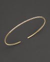 A simply modern diamond bangle in 14K yellow gold from Meira T.