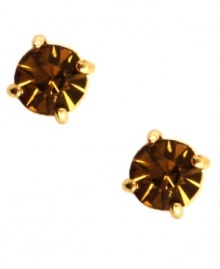 Go for sultry color with Anne Klein's stud earrings. Round-cut cubic zirconia in topaz hues complement your seasonal looks. Set in gold tone mixed metal. Approximate diameter: 1/3 inch. Go for sultry color with Anne Klein's stud earrings. Round-cut cubic zirconia in topaz hues complement your seasonal looks. Set in gold tone mixed metal. Approximate diameter: 1/3 inch.