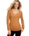 Tonal sequins at the neckline elevate Debbie Morgan's V-neck sweater. Pair it with skinny jeans for an on-point ensemble.