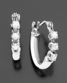 Tiny hoops add subtle sparkle to your look with glittering round-cut diamonds (1/8 ct. t.w.). Earrings set in 14k white gold. Approximate diameter: 1/4 inch. Tiny hoops add subtle sparkle to your look with glittering round-cut diamonds (1/8 ct. t.w.). Earrings set in 14k white gold. Approximate diameter: 1/4 inch.