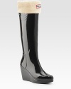 Glossy rubber rainwear now revamped with an embossed Hunter crest and solid rubber wedge.Heel, 3 (75mm) Rubber platform, ½ (15mm) Compares to a 2½ heel (65mm) Shaft, 14 Leg circumference, 15 Round toe Pull-on style Padded insole Rubber sole ImportedOUR FIT MODEL RECOMMENDS ordering true whole size; ½ sizes should order the next whole size up. 