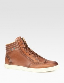 Cuir leather with web loop at ankle.Padded back ankleRubber sole embossed with Gucci scriptMade in Italy