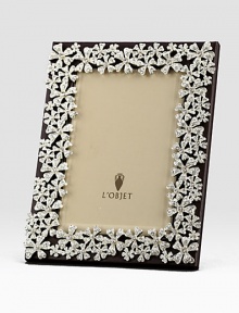 White Swarovski crystals shimmer on the platinum tone floral garland that surrounds this rich leather design.Holds 5 X 7 photoClassic beveled glassStretched leather backingGift boxedImported