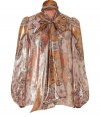 With a 1970s-inspired silhouette, this Emilio Pucci lurex blouse seamlessly combines playful style with sophistication - Tie-neck collar, long puff sleeves, concealed front button placket, relaxed silhouette, all-over floral and paisley print - Style with high-waisted jeans, sky-high platform pumps, and a chain-detailed shoulder bag