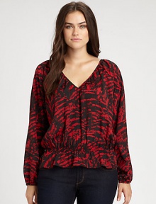 Pull on this printed blouse featuring a decolletage-complementing neckline. Its comfortable cinched waist ensures a feminine silhouette.V-necklineLong sleevesElasticized cuffsAllover printElasticized waistAbout 24 from shoulder to hemPolyesterMachine washImported