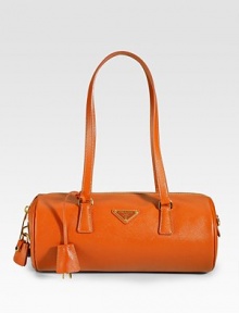 Rounded leather design has signature logo details, covered keys and lock embellishment. Double top handles, 10 Zipper closure Inside zipper pocket Signature jacquard lining 11½W X 5H X 5D Made in Italy Rounded leather design has signature logo details, covered keys and lock embellishment. Double top handles, 10 Zipper closure Inside zipper pocket Signature jacquard lining 11½W X 5H X 5D Made in Italy