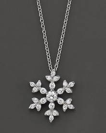 A diamond snowflake pendant has a round center stone. Set in 14 Kt. white gold. A diamond snowflake pendant has a round center stone. Set in 14 Kt. white gold.