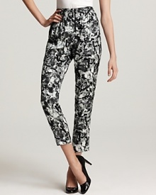 Patterned with black and grey florals, these tapered Theory pants come complete with a ruffled waistline for fabulously feminine flair. Emulate the runway with a tucked-in blouse and your favorite pointy-toe stilettos. Patterned with black and grey florals, these tapered Theory pants come complete with a ruffled waistline for fabulously feminine flair. Emulate the runway with a tucked-in blouse and your favorite pointy-toe stilettos.