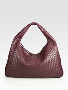 Rich woven leather design finished with a smooth shoulder strap. Shoulder strap, 4½ drop Top zip closure One inside zip pocket Suede lining 12H X 18L X 2½W Made in Italy Rich woven leather design finished with a smooth shoulder strap. Shoulder strap, 4½ drop Top zip closure One inside zip pocket Suede lining 12H X 18L X 2½W Made in Italy