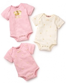 High chair haute couture: a set of three bodysuits, dotted with different Juicy logos. High chair haute couture: a set of three bodysuits, dotted with different Juicy logos.