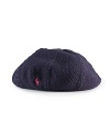 A slouchy beret exudes Parisian chic, rendered in a blend of variegated cable and flat-knit stitches for a charming look.