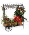 Brimming with the traditional red and green plants of Christmas, this handcrafted cart complements the Cries of London figurines, also from Byers' Choice.
