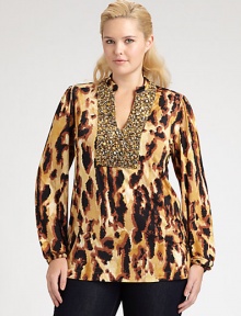 A stunning abstract animal print in an easy shape with a little stretch is richly embellished with beads and sequins at the neckline and bib for a striking, shimmering effect.Round band necklineOpen V notch, outlined in beadingLong sleeves with elasticized band cuffsBack yokeAbout 29 from shoulder to hemVenezia polyester/spandexDry cleanMade in USA