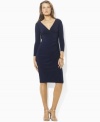 Shirring at one side creates a sleek, flattering silhouette, rendered in smooth matte jersey for a look of smart sophistication on this petite Lauren by Ralph Lauren dress.