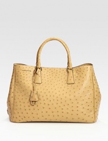 Luxe ostrich skin in a top-handle carryall.Double top handles, 5 dropTop snap closureProtective metal feetOne inside zip pocketThree inside open pocketsLeather lining14W X 10¼H X 7DMade in Italy Luxe ostrich skin in a top-handle carryall.Double top handles, 5 dropTop snap closureProtective metal feetOne inside zip pocketThree inside open pocketsLeather lining14W X 10¼H X 7DMade in Italy